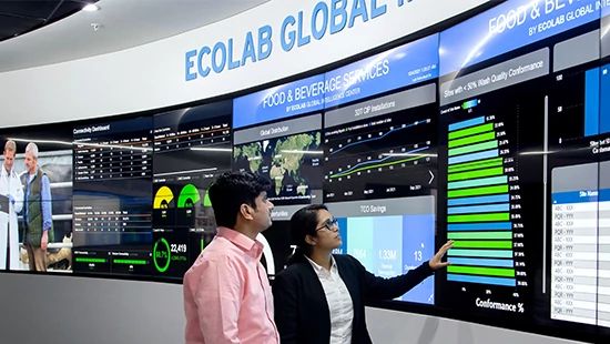 Person Holding Stack of Plates in Commercial Kitchen